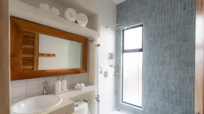 a bathroom with a sink and a toilet and a mirror at New! 5-Min Walk to Surf - Private Pool - 2BR in Playa hermosa