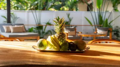 a plate with a pineapple and fruit on a table at New! 5-Min Walk to Surf - Private Pool - 2BR in Playa hermosa