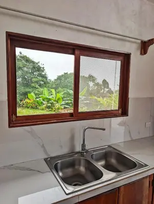 a kitchen sink with a window above it at Villa Piedra Viva in Tilarán