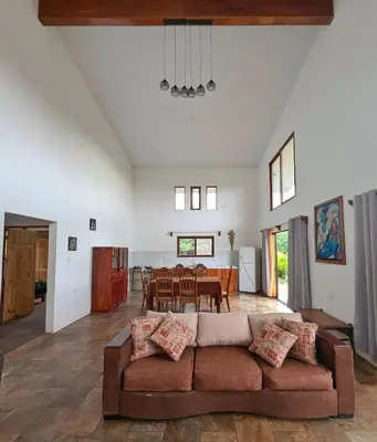 a living room with a couch and a table at Villa Piedra Viva in Tilarán