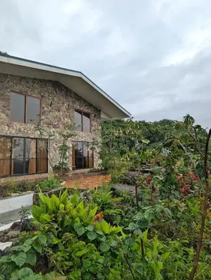 a stone house with a garden in front of it at Villa Piedra Viva in Tilarán