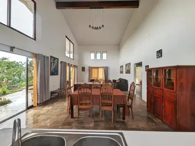 a kitchen and dining room with a table and chairs at Villa Piedra Viva in Tilarán