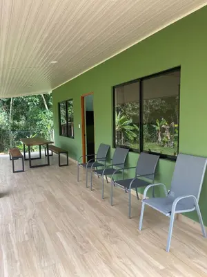 a waiting room with chairs and a green wall at Casa Ema in La Abuela