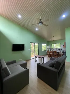 a living room with a couch and a television and a table at Casa Ema in La Abuela