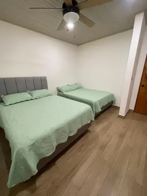 two beds in a bedroom with a ceiling at Casa Ema in La Abuela