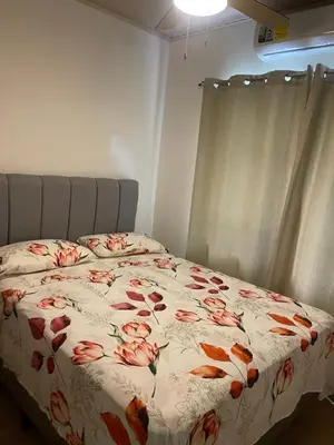 a bedroom with a bed with a floral comforter at Casa Ema in La Abuela