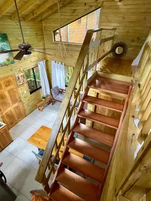 an overhead view of a wooden staircase in a log cabin at Finca Los Mangos in Quepos