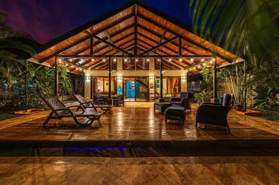 a lobby of a house with chairs and tables at Casa de los Lorros close to whale tail in Bahia