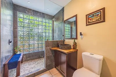 a bathroom with a shower and a toilet and a sink at Casa de los Lorros close to whale tail in Bahia