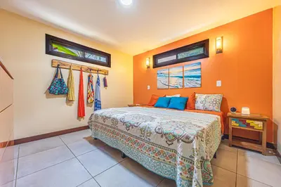 a bedroom with a bed and two windows at Casa de los Lorros close to whale tail in Bahia