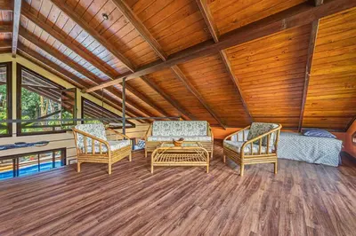 a living room with two chairs and a table at Casa de los Lorros close to whale tail in Bahia