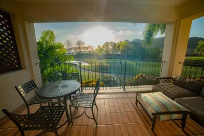 a screened in porch with a couch and a table and chairs at Del Mar 1G 3 bdr - 2bth ocean view in Herradura