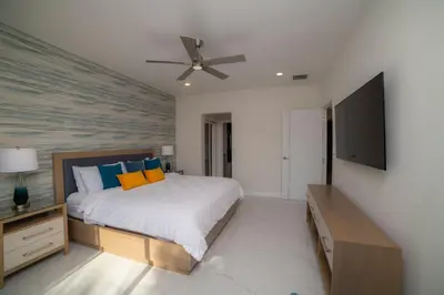a bedroom with a bed and a flat screen tv at Del Mar 1G 3 bdr - 2bth ocean view in Herradura