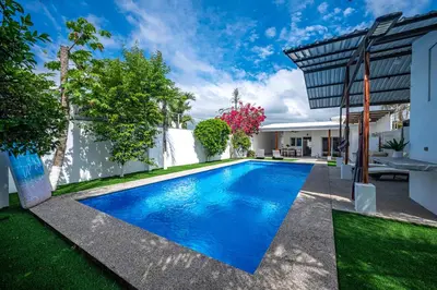 a swimming pool in the backyard of a house at Casa Alegria in Jacó