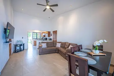 a living room with a couch and a table at Casa Alegria in Jacó