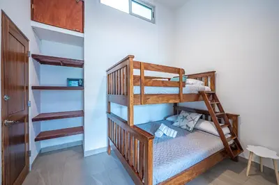 a bunk bed in a room with a bunk bed in a room at Casa Alegria in Jacó