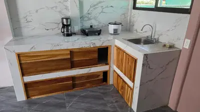 a kitchen with a sink and a counter top at Paquera apartment in Paquera