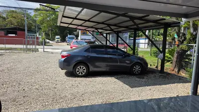 a small car parked under a parking lot at Paquera apartment in Paquera