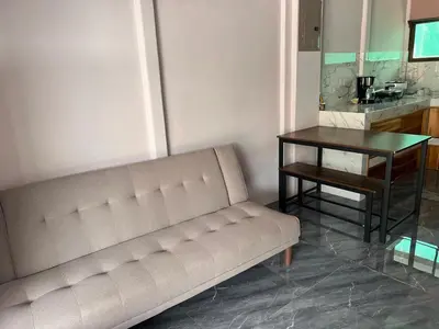 a living room with a couch and a table at Paquera apartment in Paquera
