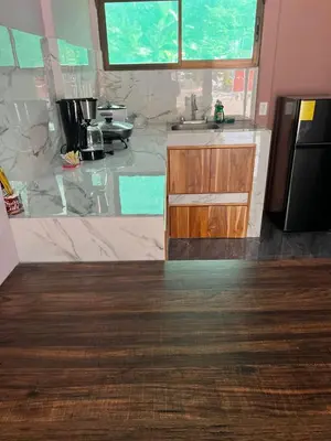 a kitchen with a sink and a counter top at Paquera apartment in Paquera