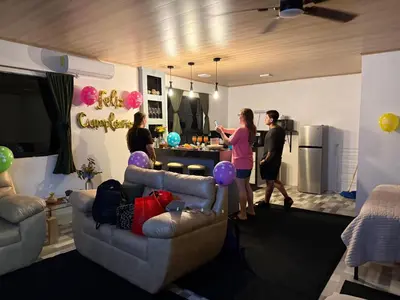 a group of people standing in a living room at Arenal cautiva in El Castillo de La Fortuna