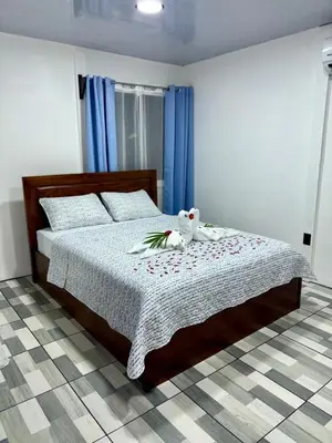 a bedroom with a bed with a teddy bear on it at Casa de las aves in Guayabal