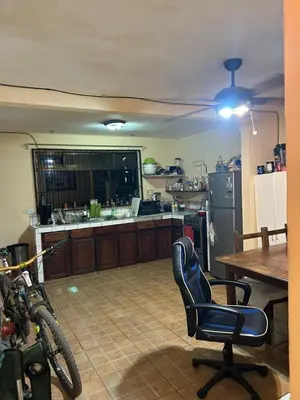 a kitchen with a table and a chair in a room at Surf House Aparment in Coco