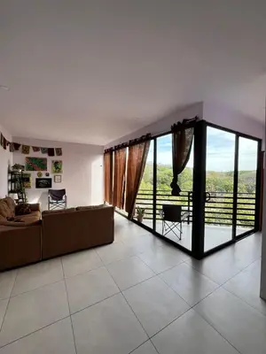 a living room with a couch and sliding glass doors at Golden Sunset Loft in Tamarindo