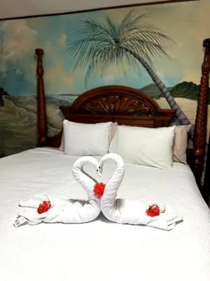 two towels shaped like swans are on a bed at Walk-out Beachfront Condo - Surfer's Paradise in Playa Hermosa