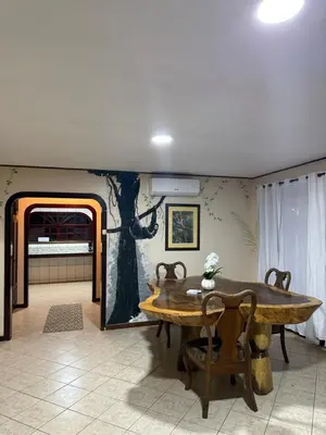 a dining room with a table and a tree mural at Walk-out Beachfront Condo - Surfer's Paradise in Playa Hermosa
