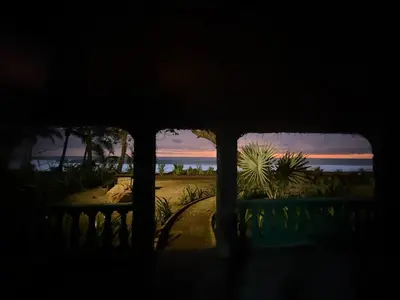 a view of the beach from a house at sunset at Walk-out Beachfront Condo - Surfer's Paradise in Playa Hermosa