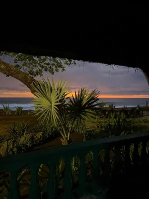 a view of the sunset from a balcony at Walk-out Beachfront Condo - Surfer's Paradise in Playa Hermosa