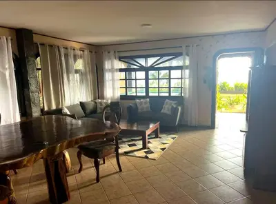a living room with a table and a couch at Walk-out Beachfront Condo - Surfer's Paradise in Playa Hermosa