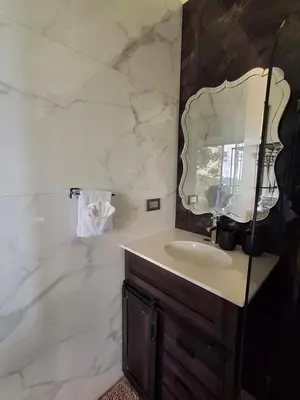 a bathroom with a sink and a mirror at Casita El Perezoso in San Rafael