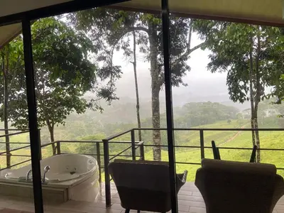 a bath tub sitting on a balcony with a view at Casita El Perezoso in San Rafael