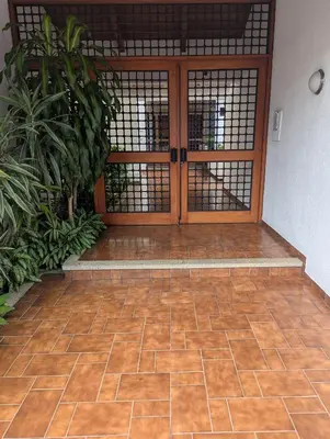 a wooden door in a room with plants at Habitación Sabana in San José