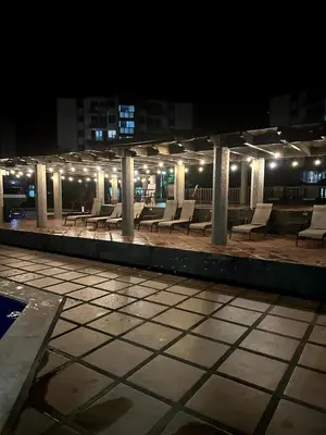 a row of chairs on a rooftop at night at CL127 Modern Penthouse in Jacó