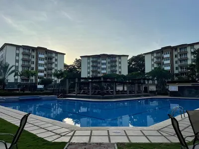 a swimming pool in front of some apartment buildings at CL127 Modern Penthouse in Jacó