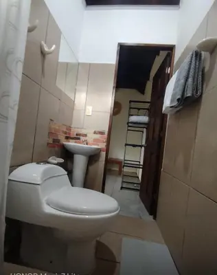 a small bathroom with a toilet and a sink at Green Point Nature Retreat in Nosara