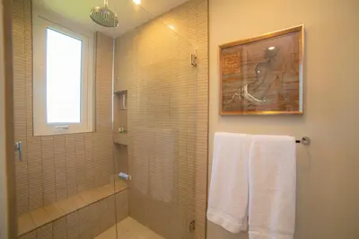 a bathroom with a walk in shower and a glass shower at Miramar 2D -3 bedr 3 bath Ocean View in Herradura