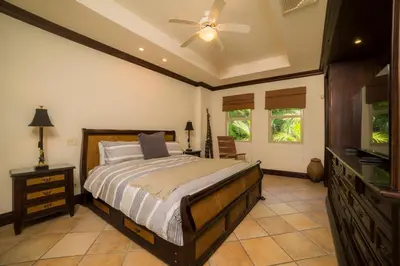 a bedroom with a bed and a ceiling fan at Marbella 2A 3 BR in La Mona