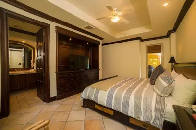 a bedroom with a bed and a flat screen tv at Marbella 2A 3 BR in La Mona