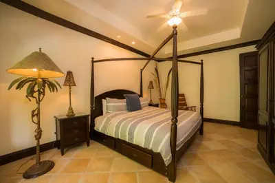 a bedroom with a canopy bed and a lamp at Marbella 2A 3 BR in La Mona