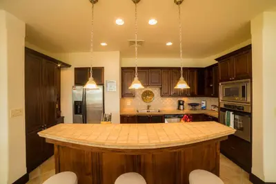 a kitchen with wooden cabinets and a large island at Marbella 2A 3 BR in La Mona