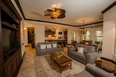 a living room with a couch and a tv and a table at Marbella 3D 3 BR Ocean View in La Mona