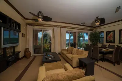 a living room with a couch and a table and a tv at Montebello 1C - 3 bdr 3 bath Ocean view in La Mona