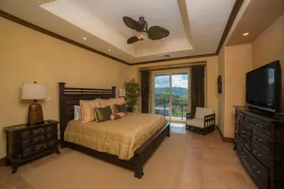 a bedroom with a bed and a flat screen tv at Montebello 1C - 3 bdr 3 bath Ocean view in La Mona