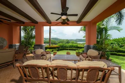 a patio with chairs and a table and a ceiling fan at Montebello 1E 3 bed 3 bath ocean view in La Mona
