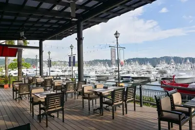 a patio with tables and chairs and a marina at Montebello 1E 3 bed 3 bath ocean view in La Mona