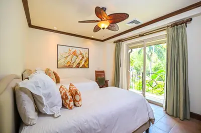 a bedroom with a bed with a ceiling fan and a window at Montebello 2C - 3 bdr 3 bath Ocean View in La Mona